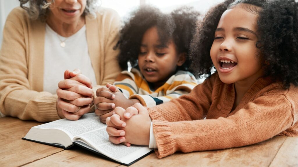 Bible, worship or grandmother praying with kids or siblings for prayer, support or hope in Christianity. Children education, family or old woman studying,